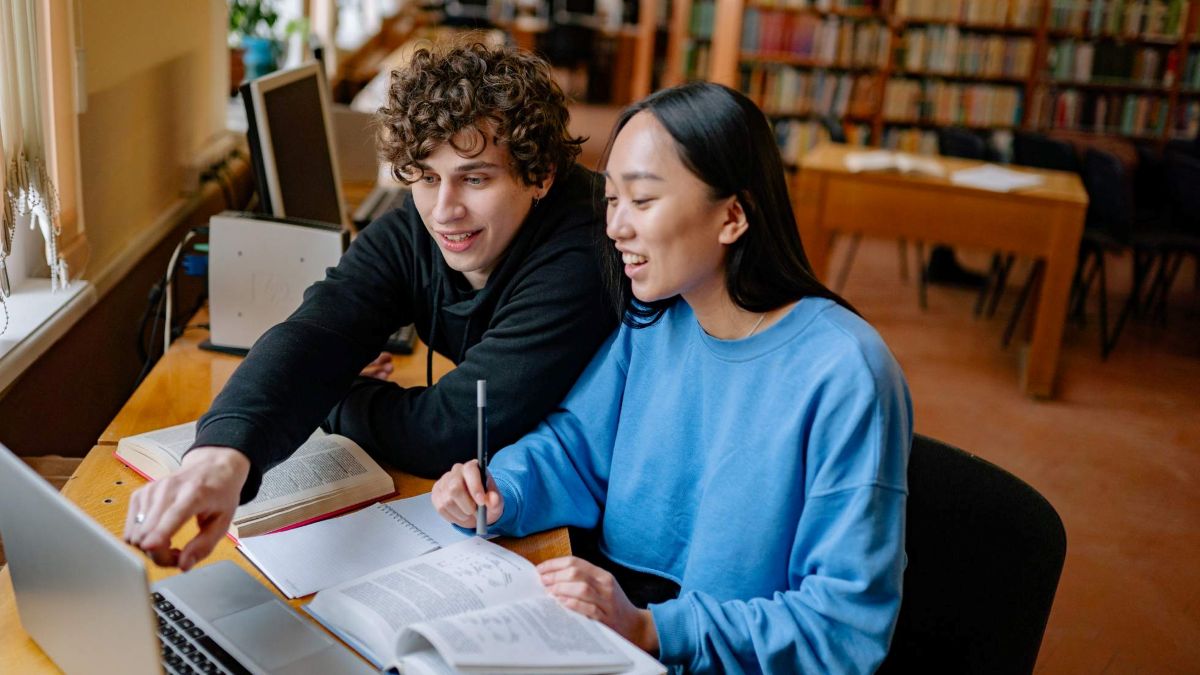 two students working on homework and studying together