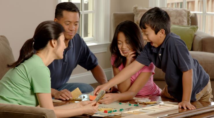 family playing board game