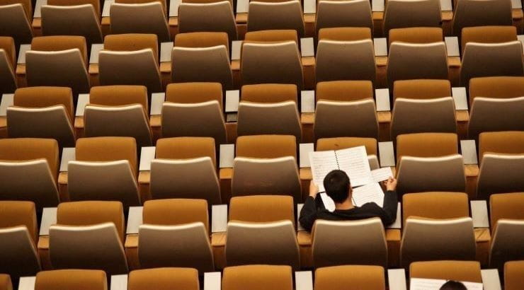 student in empty classroom