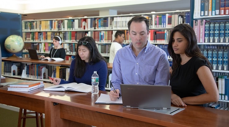 man and woman working on laptop