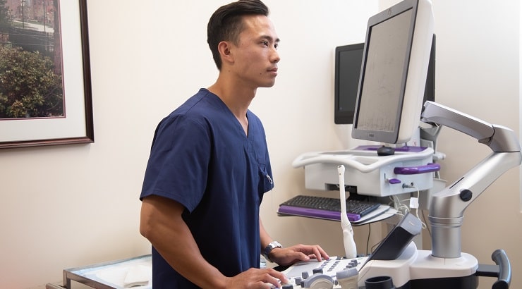 man looking at sonogram