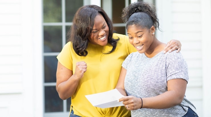 mother and daughter holding letter
