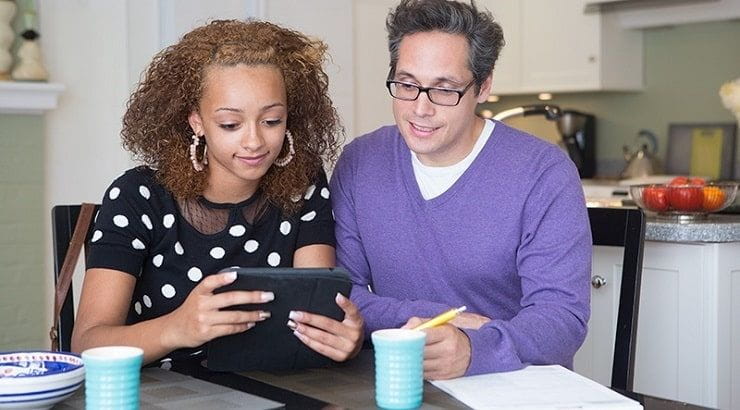 daughter and dad working on tablet