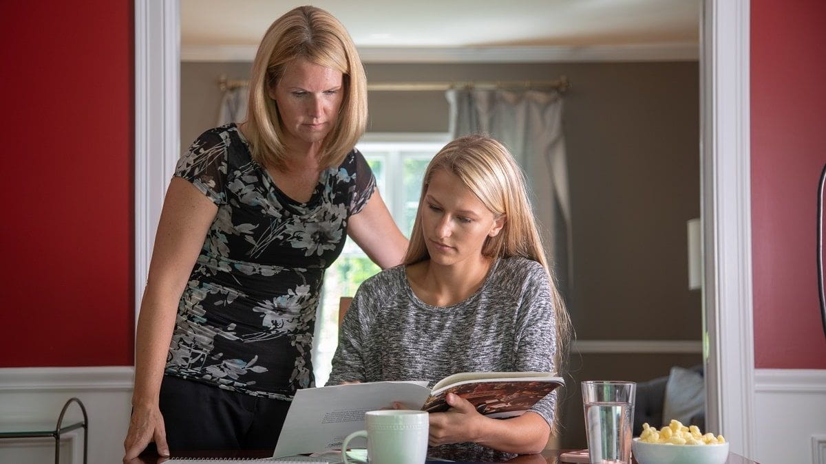 mother and daughter looking at college brochures