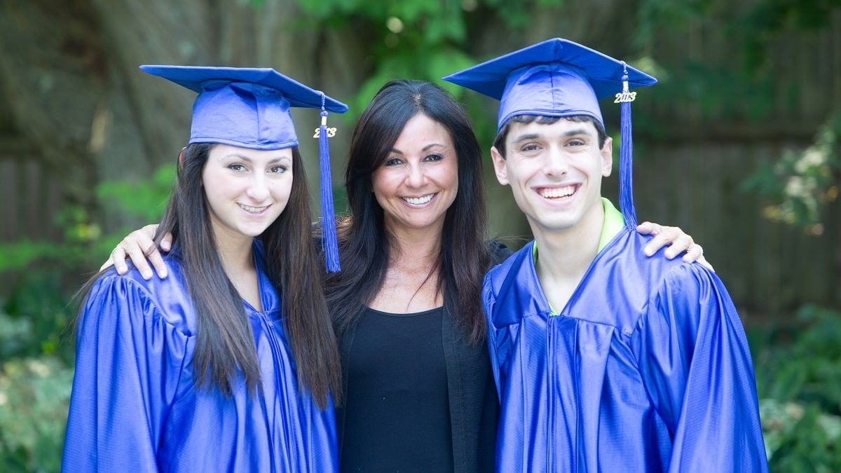 mom posing with recent graduates