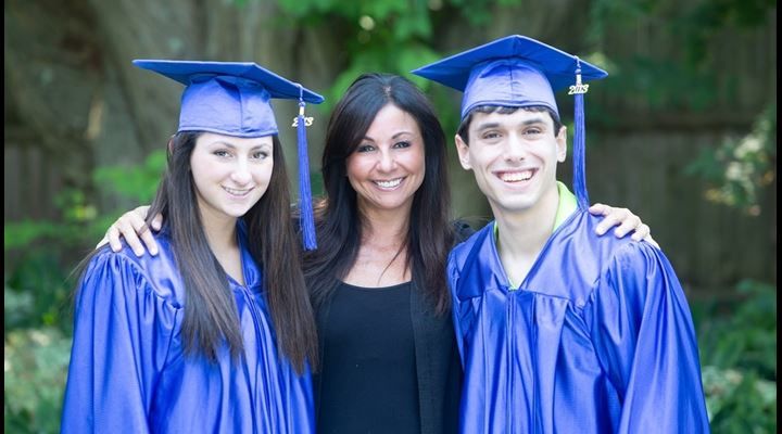 mom posing with recent graduates