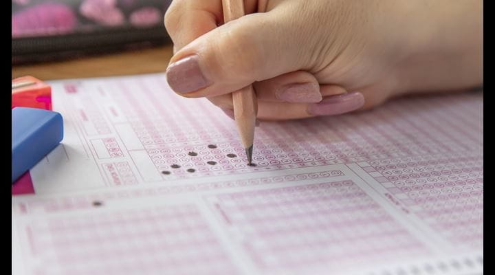 person filling out standardized test