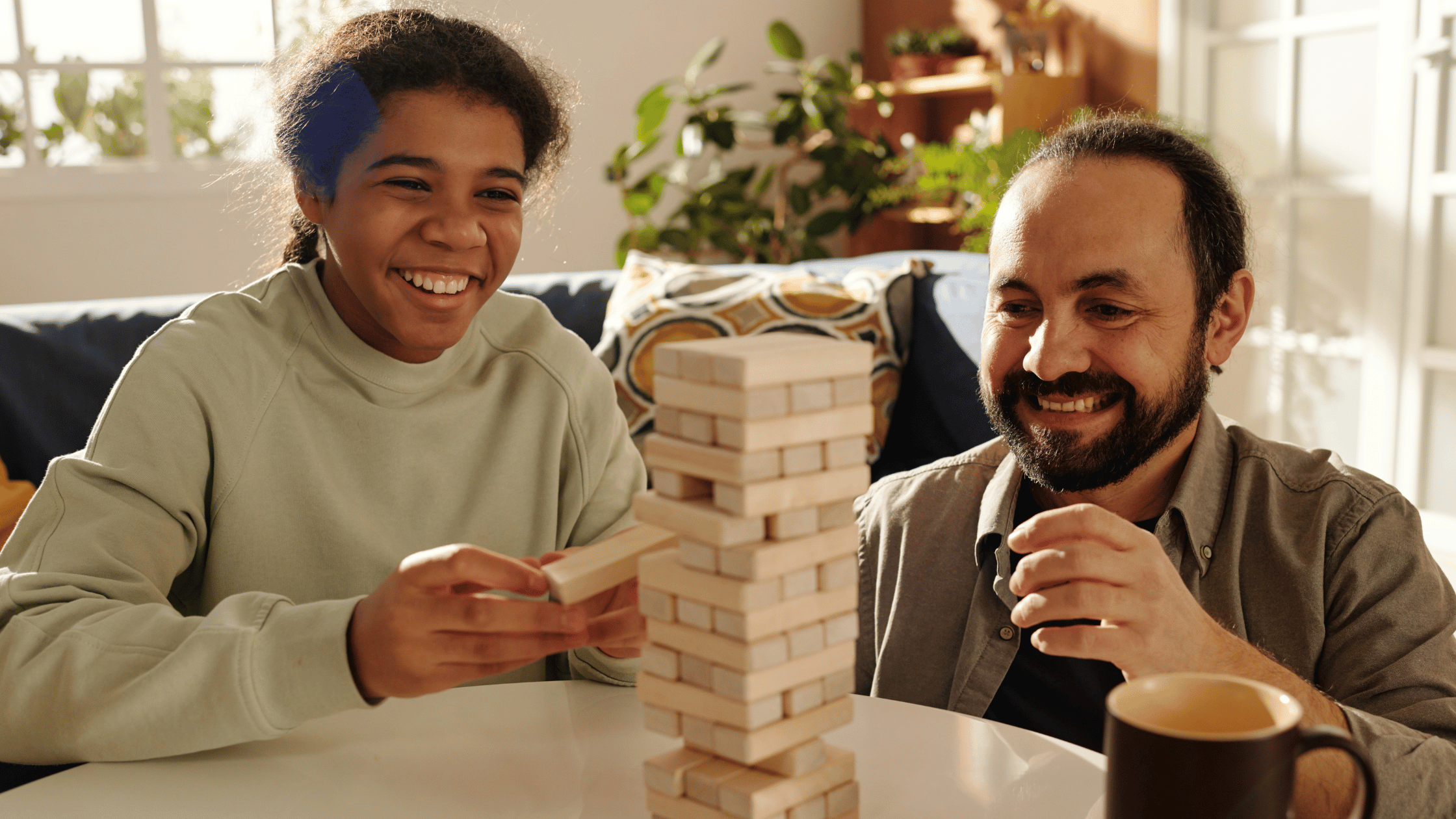 father and daughter playing jenga
