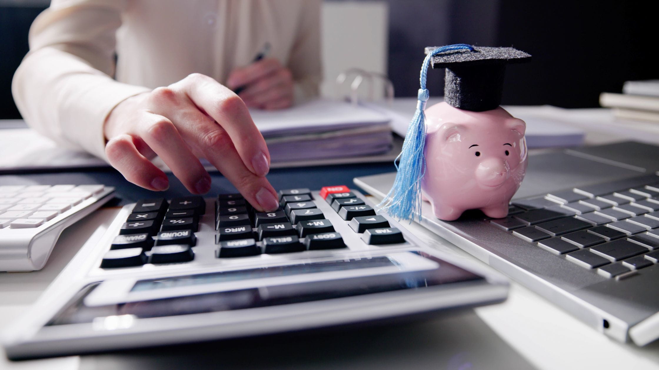 person using calculator to budget